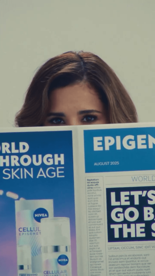 Cheryl holding a magazine featuring Nivea skincare products.