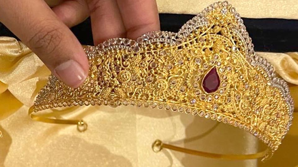 Gold crown with jewels stolen from a home.
