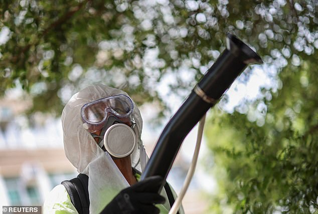 More people have been sickened in China's outbreak. Shown above is a worker spraying insecticide at a public housing estate in Hong Kong amid concerns the disease will spread
