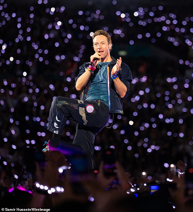 Chris Martin performs onstage during a concert at Wembley Stadium on August 22