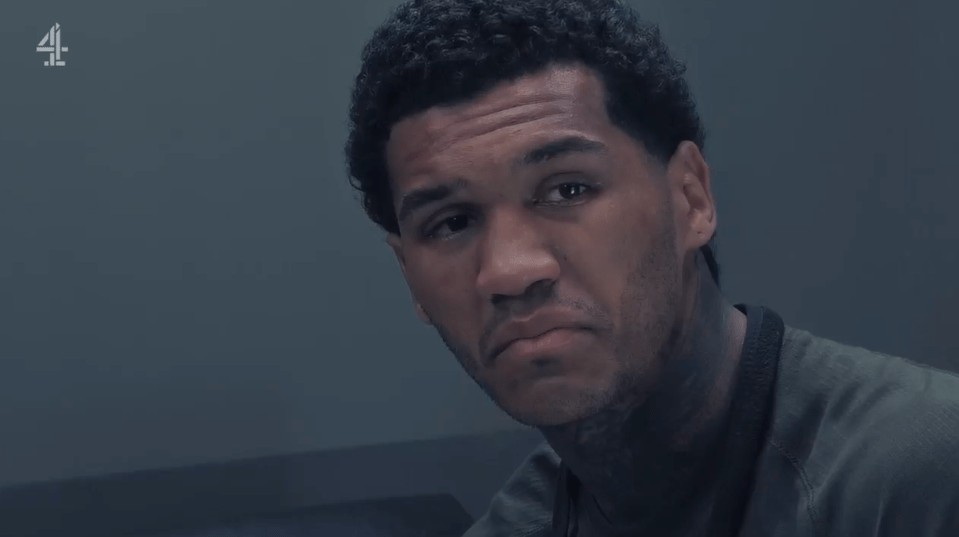 Screenshot of a man with a serious expression.
