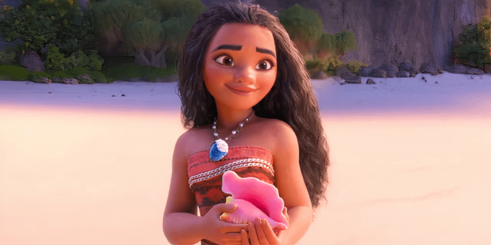 Moana holding a conch shell on a beach.