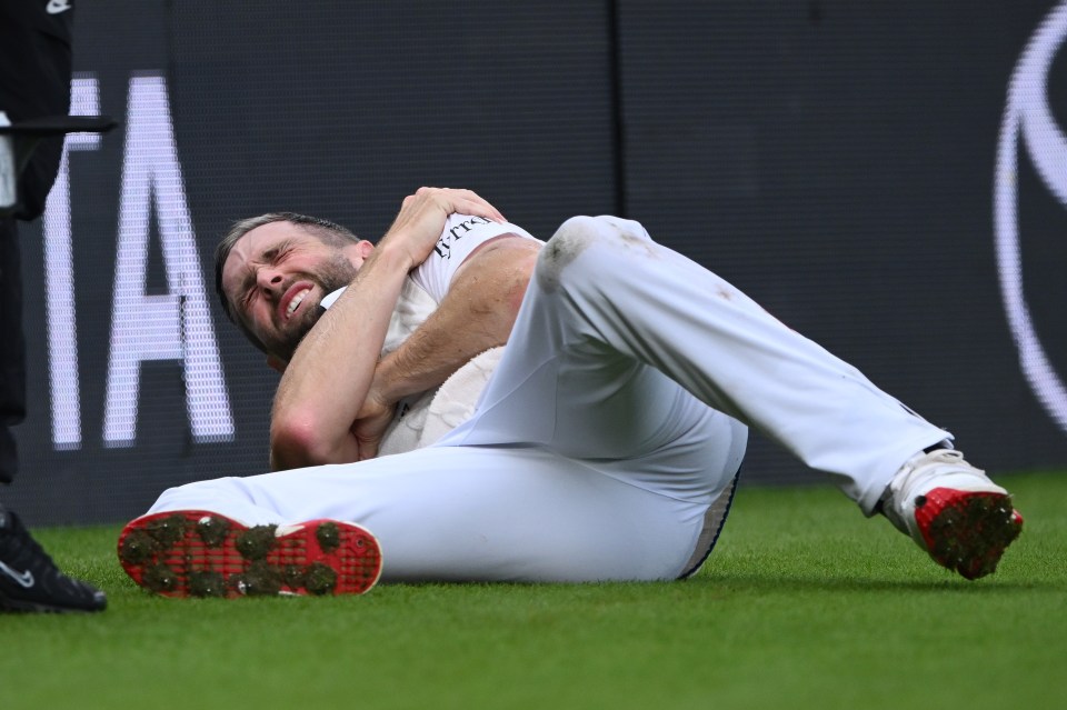 Chris Woakes of England in pain after injuring his shoulder.