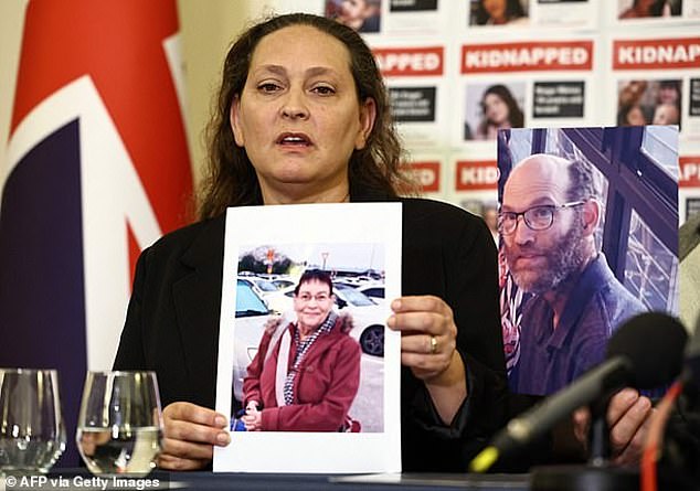 Ayelet Stavitsky, whose brothers Nadav and Roi Popplewell were killed by Hamas, holds a photograph of her mother Channah, who was kidnapped and later released