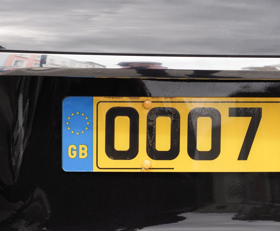 Partial view of a British car license plate showing the number 0007.