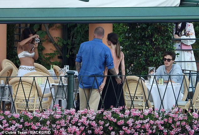 David Beckham cheekily grabbed his wife Victoria's bum during a family meal in Portofino on Friday