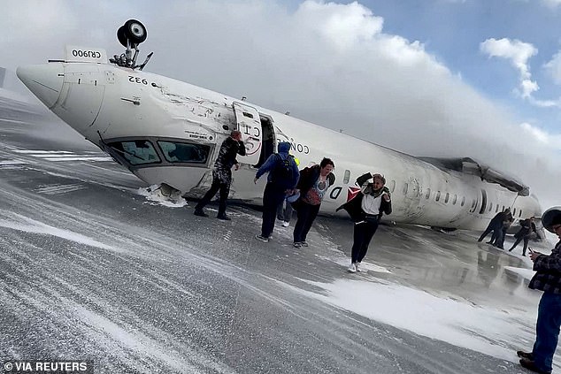 A flight attendant on board a Delta plane that crash-landed in Toronto (pictured) on February 17 claimed inexperienced pilots are to blame for the incident
