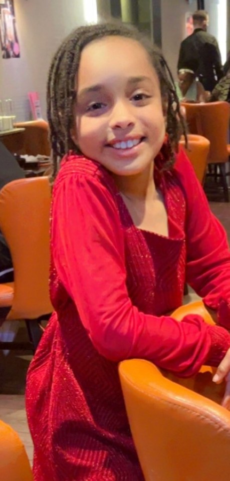 Portrait of a smiling girl in a red dress.