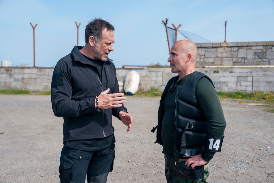 Two men talking outdoors.