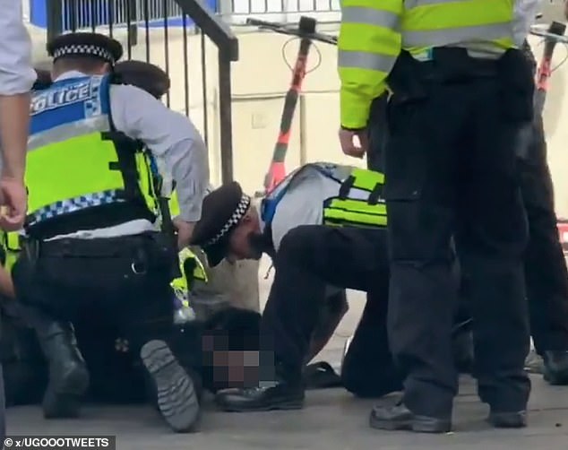 Officers removed what looked to be a balaclava from the boys face and held him down, kneeling on his legs and back