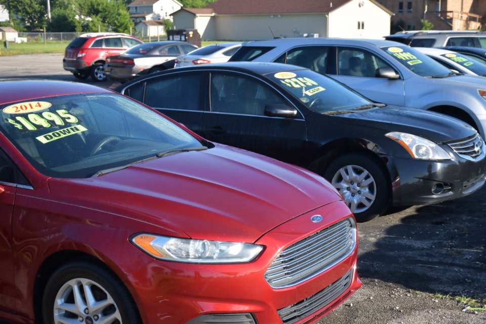 Dayton, Ohio USA June 27, 2024 A row of automobiles on display and for sale at a roadside small business used car lot.