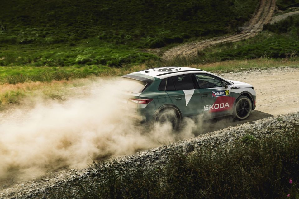 Skoda rally car kicking up dust on a dirt road.