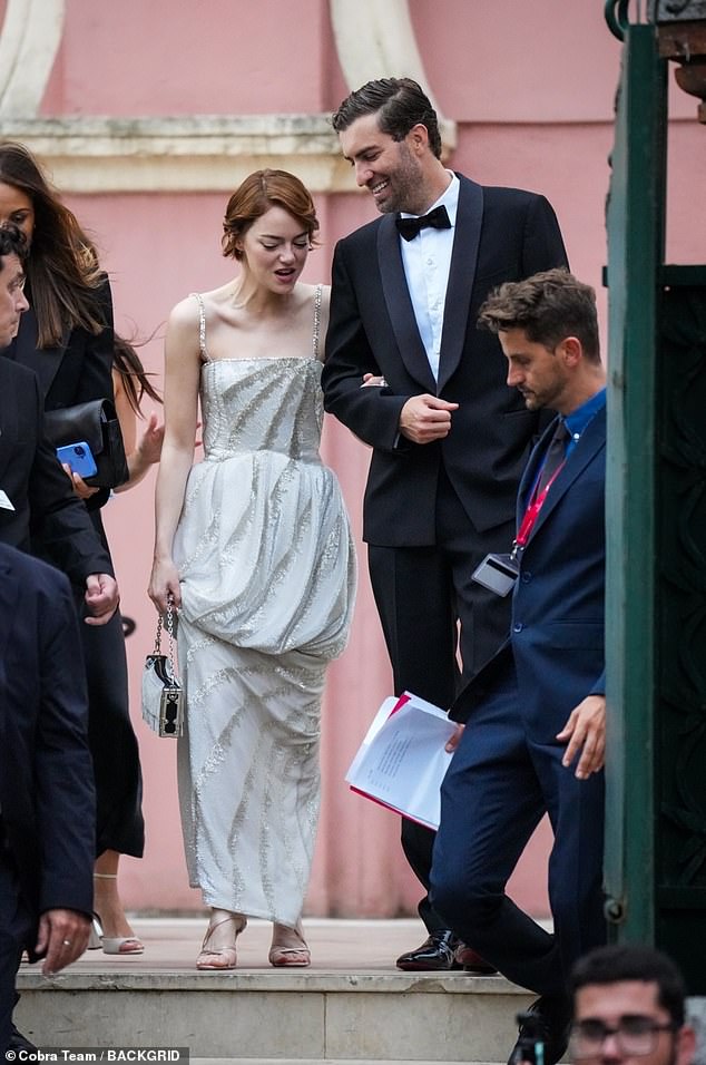 The couple were surrounded by an entourage of security and excited fans taking photographs of her as she walked down the stairs
