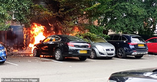 This is the alarming moment a family car went up in flames as shoppers watched in horror