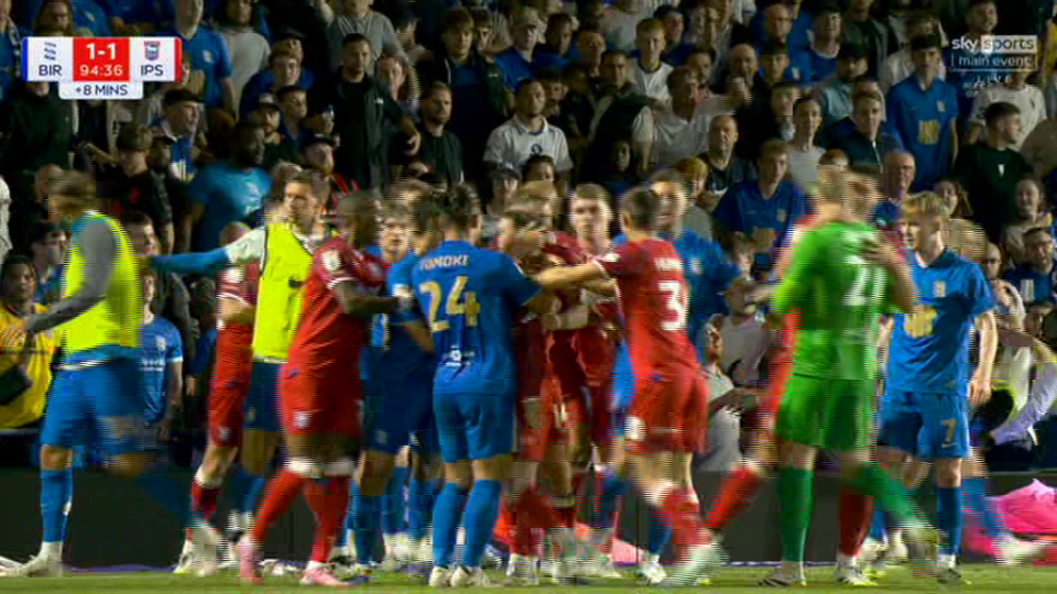 Soccer players in a heated confrontation on the field.