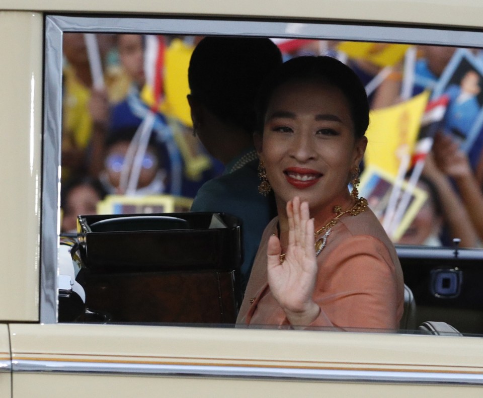 Princess Bajrakitiyabha Mahidol waving from a car.