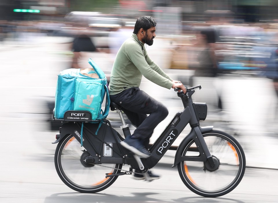 Deliveroo cyclist making a delivery in London.