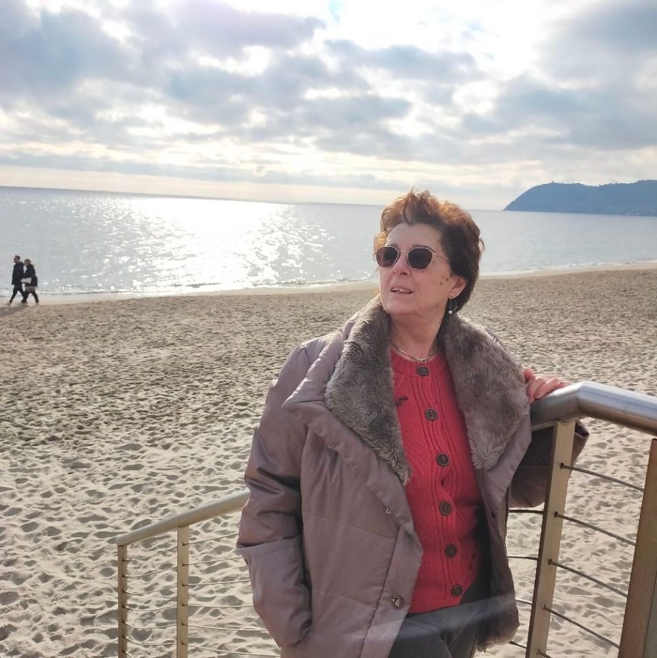 Woman in sunglasses on a beach.