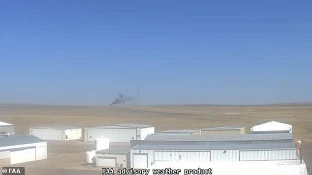 Smoke is seen through the sky near Fort Morgan Municipal Airport after the crash