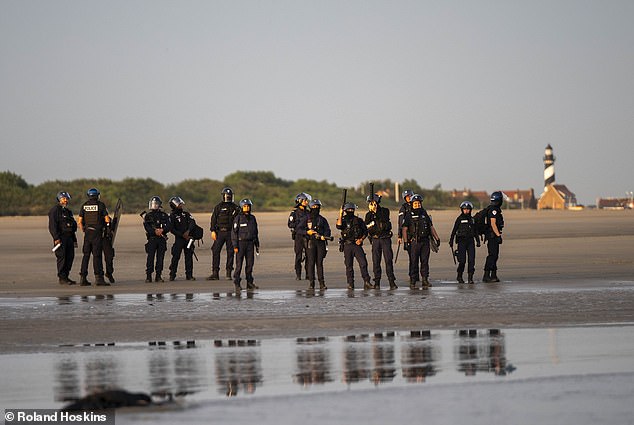 Police helplessly watched as dozens of migrants were picked up by small boat taxis from Gravelines beach in northern France
