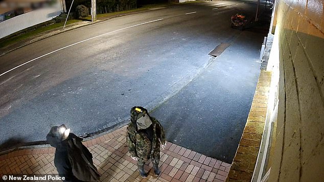 A fugitive dad who vanished into the New Zealand wilderness with his three young children has been caught on camera for the first time in a year breaking into a convenience store with one of his kids