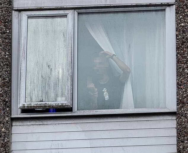 The young man was seen at the window of the Roundhouse hotel in Bournemouth, Dorset, last night, as 200 demonstrators gathered outside