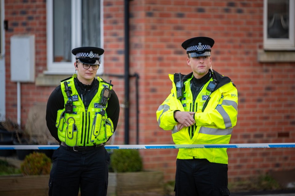 Two police officers at a scene.