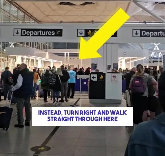 Airport security line with arrow indicating a shorter route.