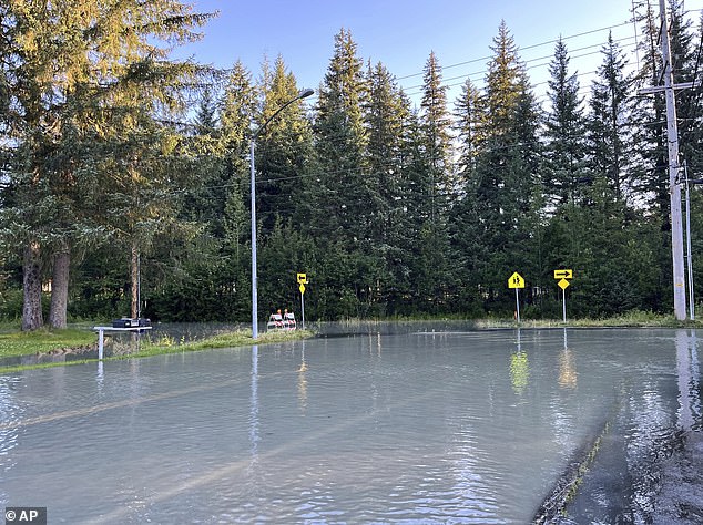 Roads across the region were closed, including Mendenhall Loop Road, which will remain off-limits until water levels drop below 12 feet and safety inspections are complete. Pictured: Flooding from a release of water and snowmelt at Mendenhall Glacier covered some roads and threatened homes along the Mendenhall River in Juneau, Alaska