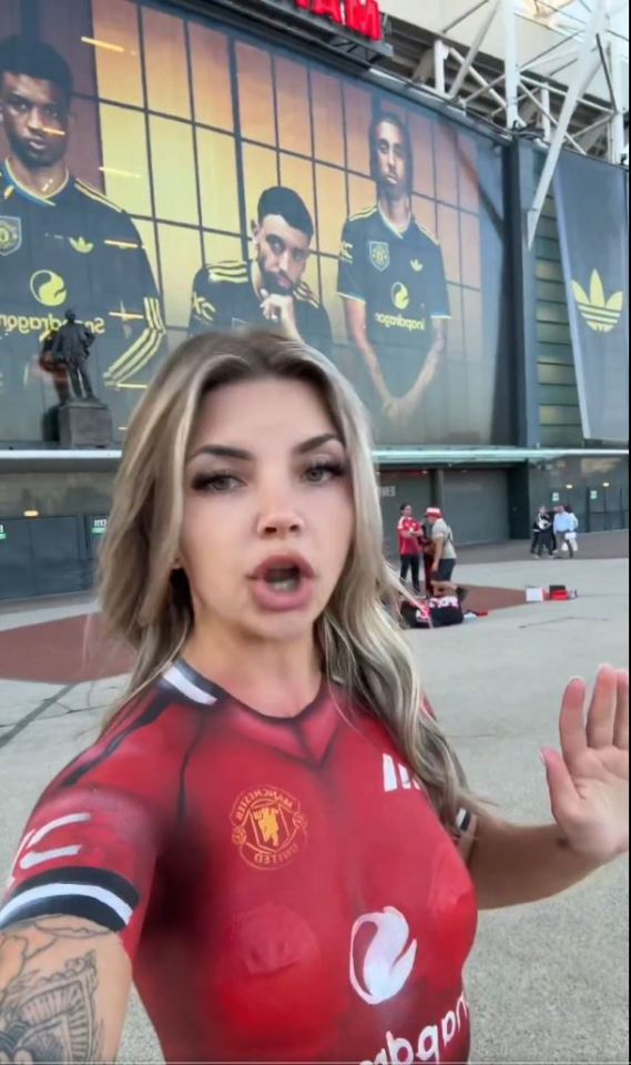 Woman with Manchester United body paint outside Old Trafford.