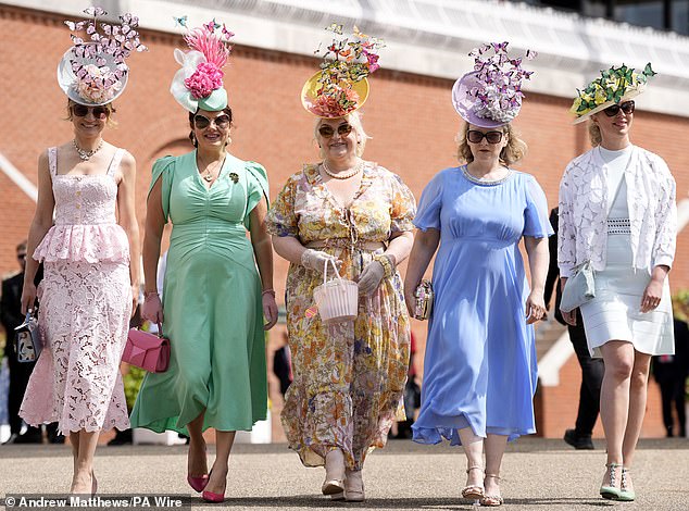 A group of friends arrive at the Chichester racecourse, wearing co-ordinating frocks in a range of pastel tones