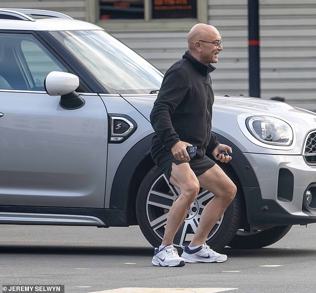 Donning a black zip-up sweater, black shorts and white trainers, Gregg looked on fine form as he warmed up by his car ahead of heading into his own training session