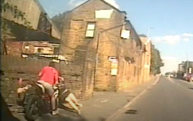 CCTV footage of a motorcyclist crashing into a pedestrian.