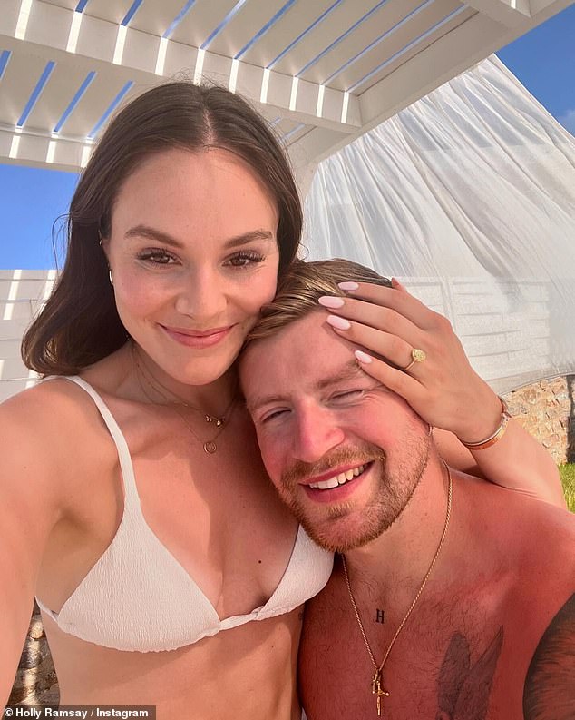 Holly and Adam announced their engagement last year with a slew of sweet Instagram snaps from their holiday in Mallorca last September (pictured)