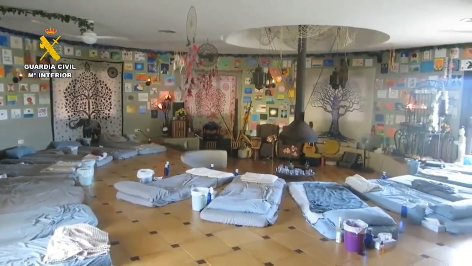 Interior of a spiritual retreat center in Spain, raided by police.  Numerous mats are arranged on the floor.