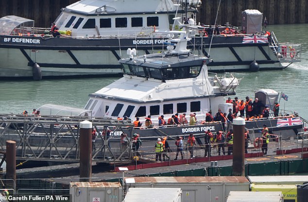 Migrants who arrive by small boat from tomorrow could face being selected for the scheme and placed in detention instead of being sent to taxpayer-funded hotels. Pictured: Arrivals in Dover last month