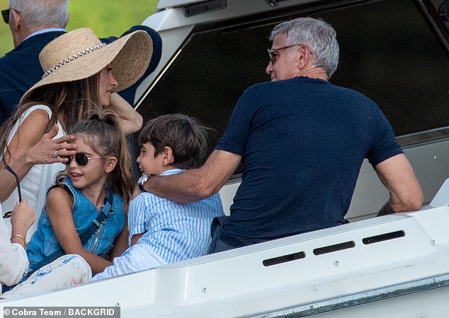 George, 64, Amal, 47, and their eight-year-old twins Ella and Alexander (all pictured) joined a mixed group of friends on Lake Como