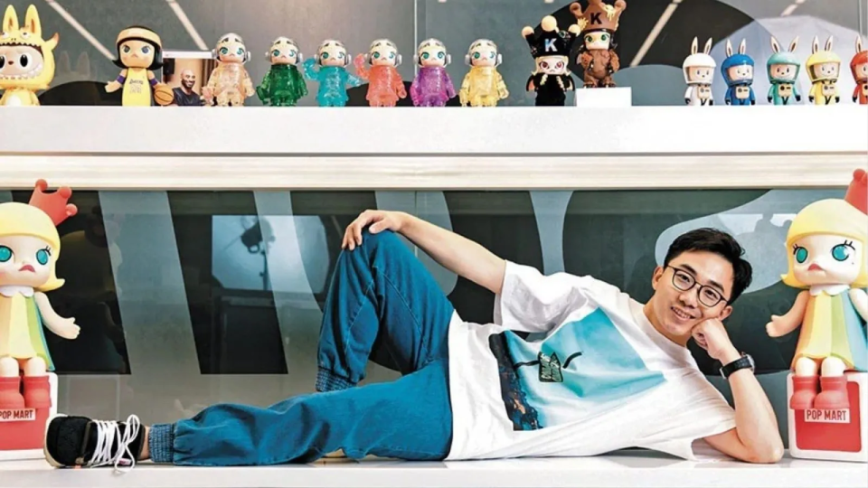 Wang Ning, CEO of Pop Mart, surrounded by Pop Mart toys.