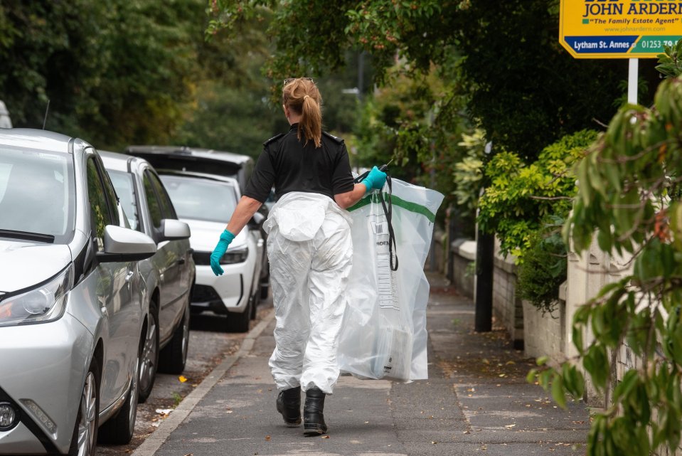 Forensic investigator carrying evidence bag.