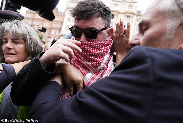 Some of the band members were concealing their faces with red, black and white Keffiyeh scarves