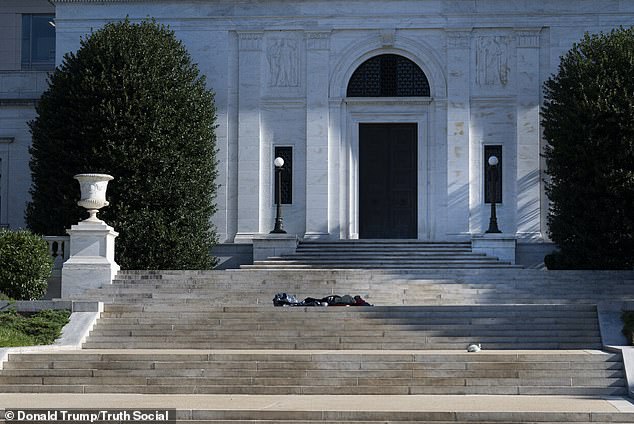 One photo sees a homeless person lying on the steps outside one of the capital's municipal buildings