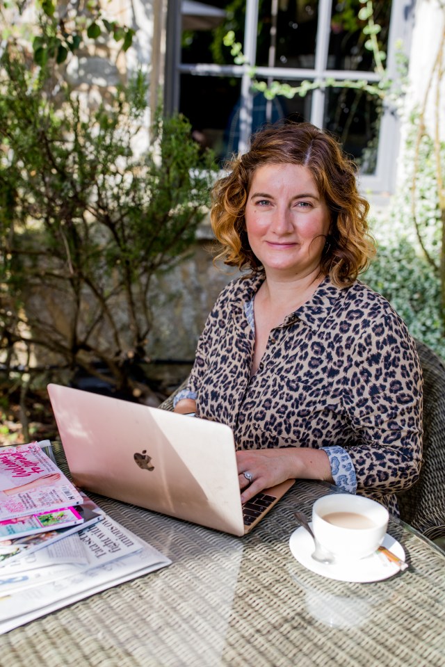 Woman working on laptop outdoors.