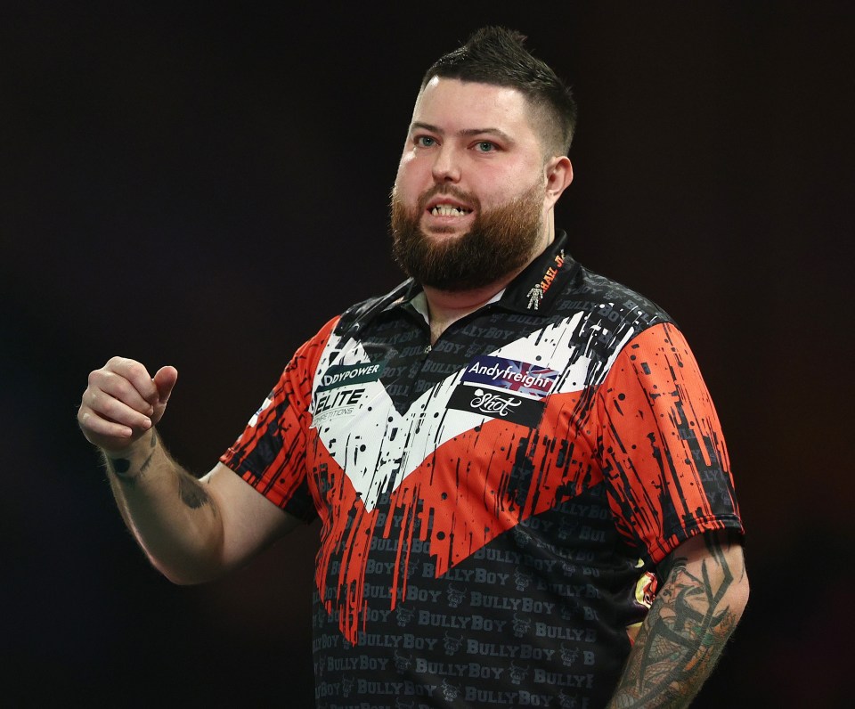 Michael Smith of England reacting during a darts match.