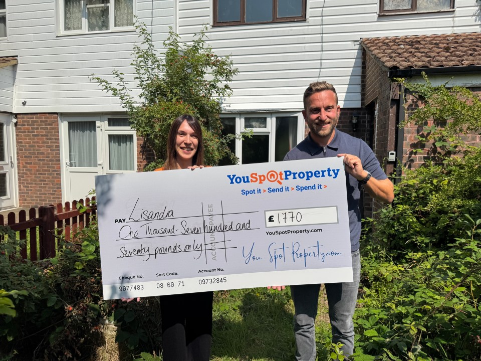 Two people holding a large check for £1770 from YouSpotProperty.com.