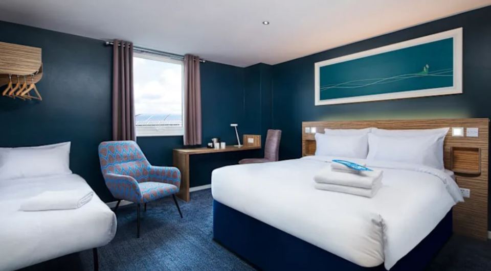 Travelodge Crawley hotel room with double bed and single bed.