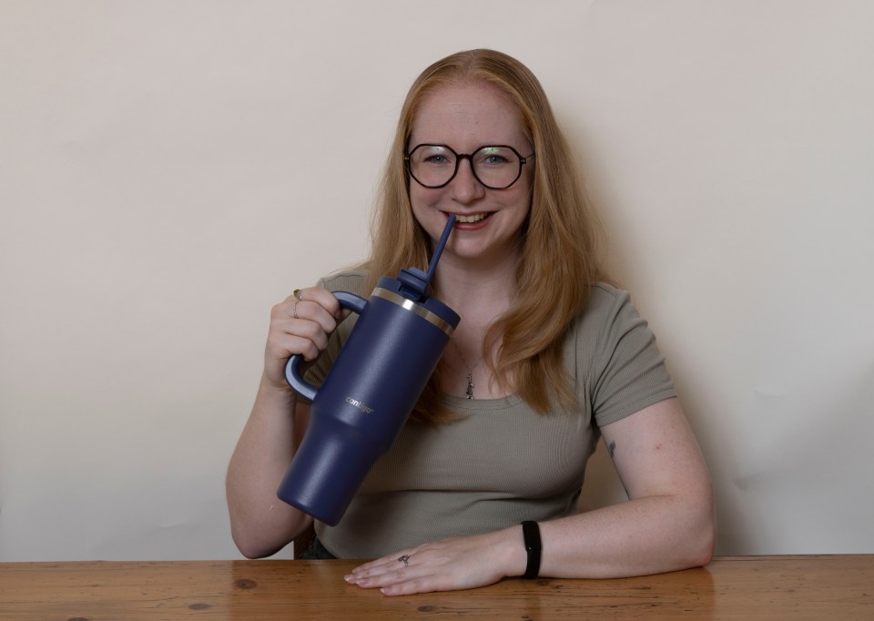 Woman drinking from a Contigo insulated water bottle.
