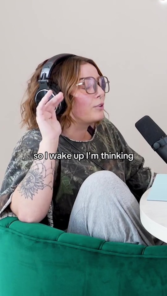 Woman wearing headphones and glasses speaks into a microphone.