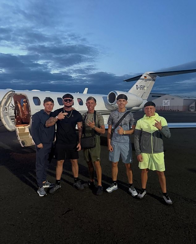 A picture shared on social media shows him surrounded by his pals in front of the jet