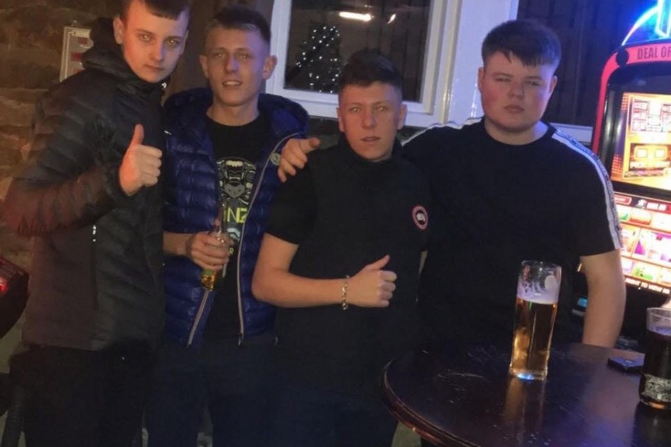 Four young men at a bar.