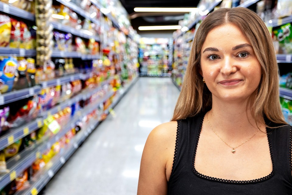 Woman in supermarket aisle.